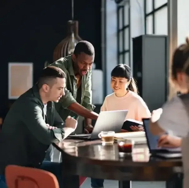 Group of people looking at a laptop