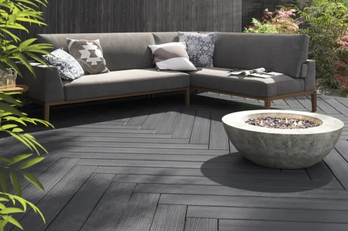 Grey decking matched with grey garden furniture and a fire pit