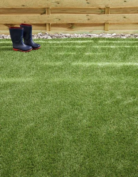 Rain boots placed on artificial grass.