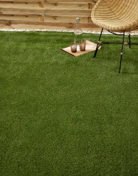 A chair and tray placed on artificial grass in an outdoor setting.