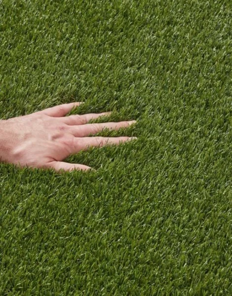 Hand on plush artificial grass